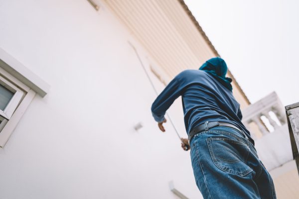 Man painting white wall house faded film look
